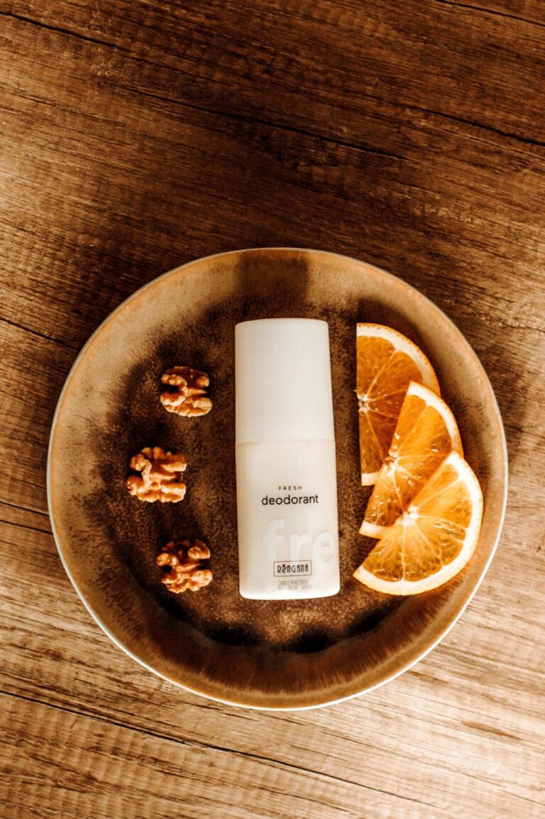 RINGANA FRESH deodorant on a plate with walnuts and orange slices