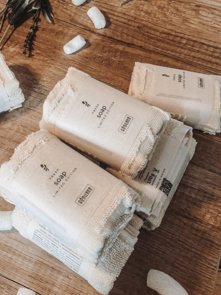 RINGANA FRESH soap bars wrapped in natural cloth on a wooden table
